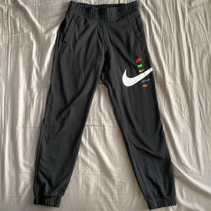 Men’s Nike sweatpants, size small, black with multicolor logo